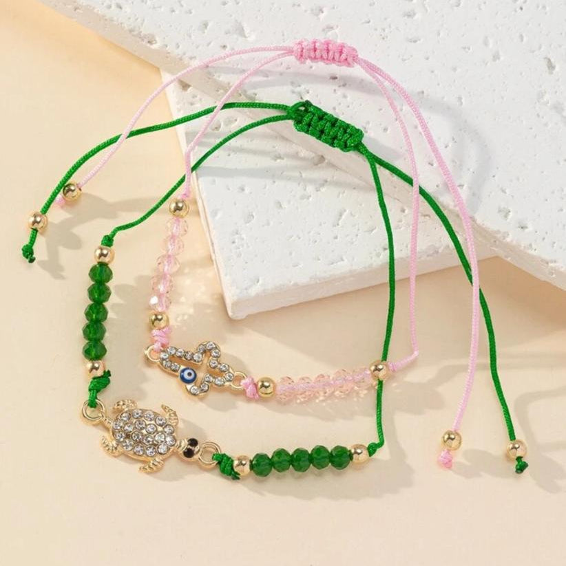 Pulsera Ajustable Con Cristales Varios Motivos Ojos Turcos, Mano de Fátima, Tortuga, Infinito (Precio Por Unidad)