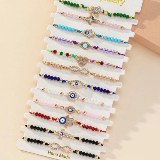 Pulsera Ajustable Con Cristales Varios Motivos Ojos Turcos, Mano de Fátima, Tortuga, Infinito (Precio Por Unidad)